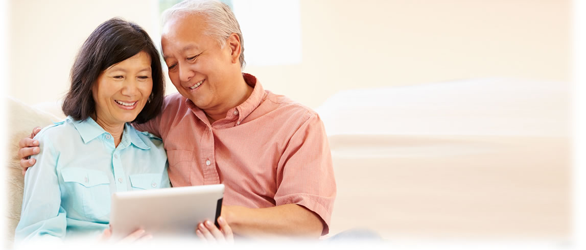 Older couple reviewing tablet information.